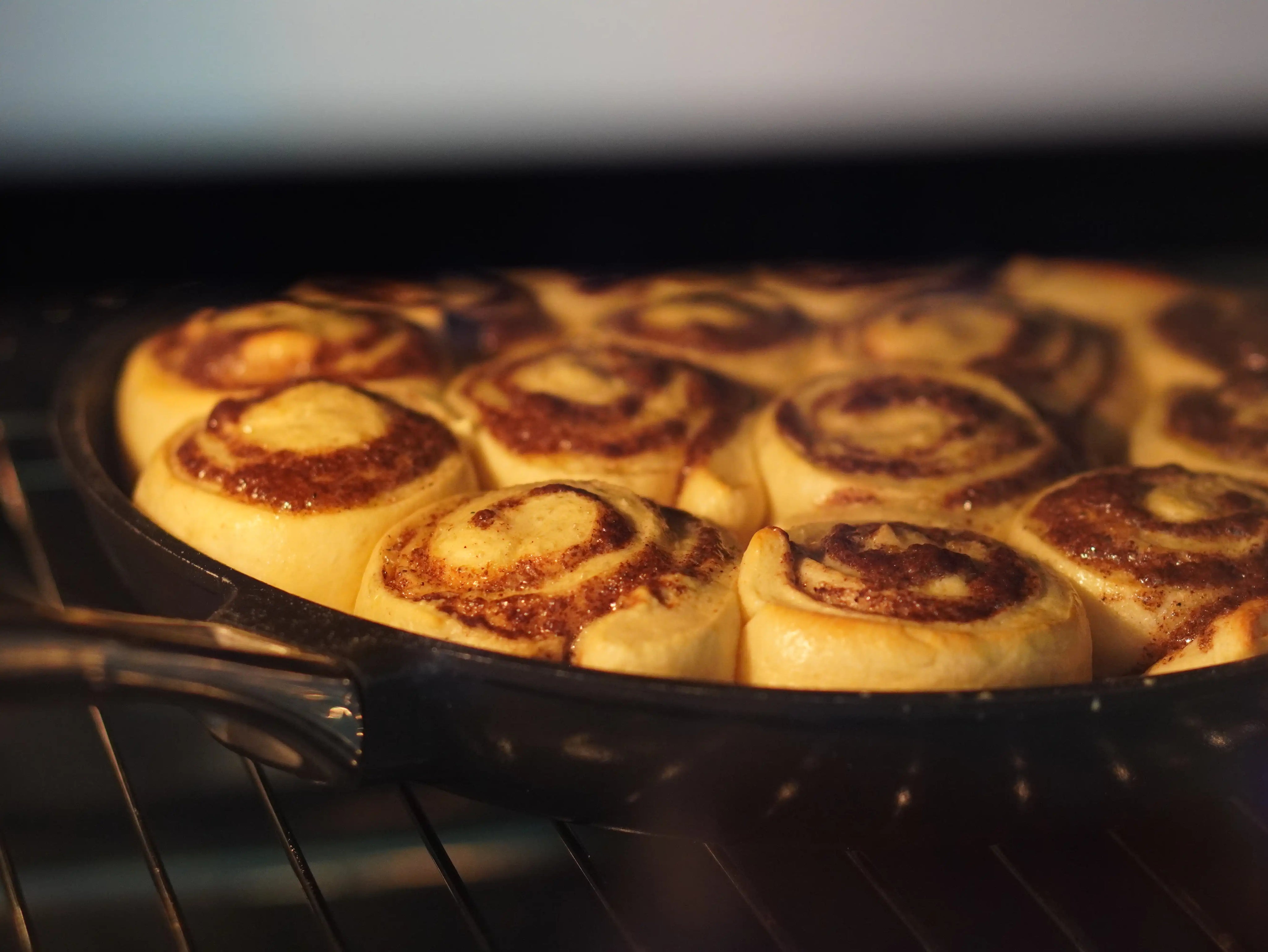 Mörk stekpanna med non-stick-yta, fylld med bakade bullar